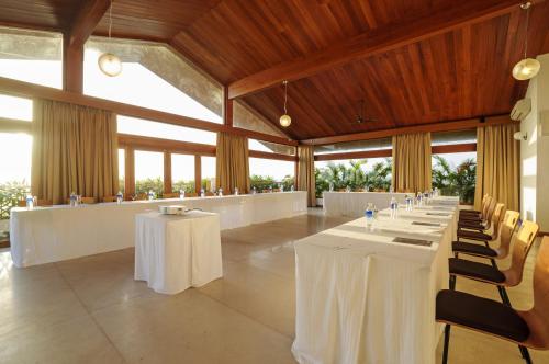 a banquet hall with white tables and chairs at Varanda Do Mar in Panaji