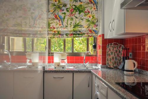 a kitchen with two sinks and a window at Ramón y Cajal by TheGoodTourist in Seville
