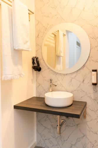 a bathroom with a sink and a mirror at Quinta dos Tojais Hotel Rural in Celorico de Basto