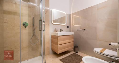 a bathroom with a shower and a sink and a toilet at Dimore Anna Maria -Il Magazzino- in Avola