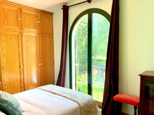 um quarto com uma cama e uma grande janela em Villa a 300 metros de playa Francón em Cangas de Morrazo