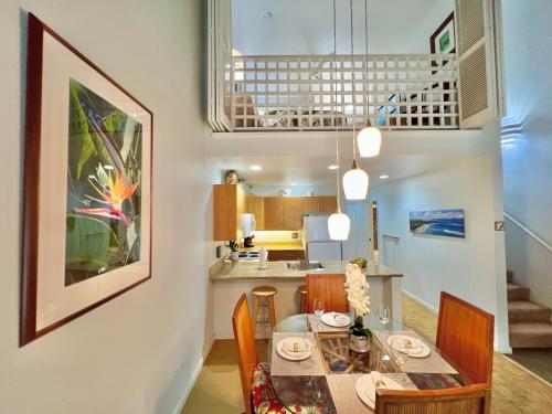 a dining room and kitchen with a table and chairs at Maui Kamaole D208 in Wailea