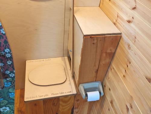 a cardboard box with a toilet in a room at Caban Delor. Off-grid glamping experience. Walking distance into Caernarfon. 20-min drive to Snowdonia or Anglesey. in Caernarfon