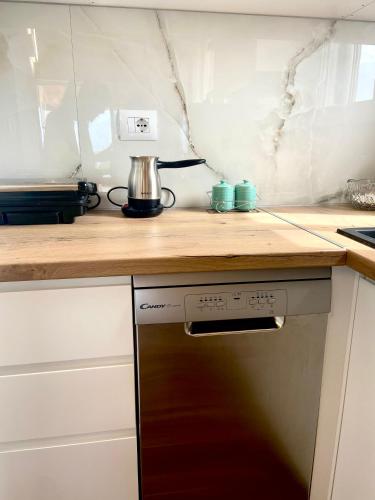 a kitchen with a counter top and a stove at Panoramic Views of Saranda in Sarandë