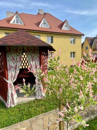 a gazebo in the yard of a house at Вілла Мозола in Skhidnitsa