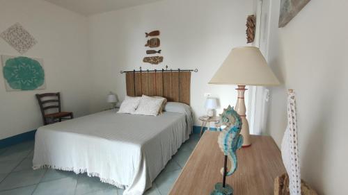 a bedroom with a bed and a table with a lamp at Sanacore - Maratea - Cersuta in Maratea