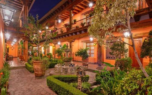 a courtyard of a building with a lot of plants at Hotel Pueblo Magico in Pátzcuaro