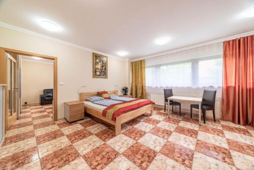 a bedroom with a bed and a table and chairs at Apartmán blizko centra Prahy in Prague