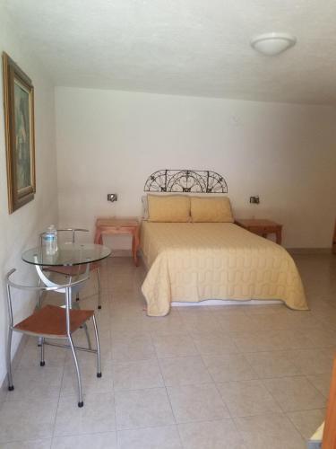 a bedroom with a bed and a table and a bed at Hotel Ollin Teotl in San Juan Teotihuacán