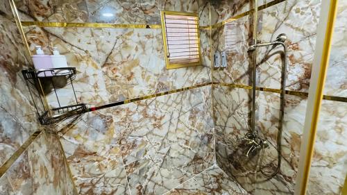 a bathroom with a shower with marble walls at Ottoman Design Apartments in Istanbul