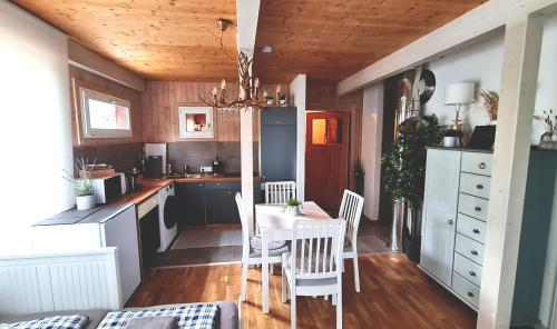 a kitchen with a table and chairs in a room at Kreischberg Chalet Ferienpark 3 in Sankt Lorenzen ob Murau