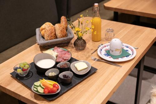 a wooden table with a tray of food on it at Jup - a luxury boutique chalet in Warth am Arlberg