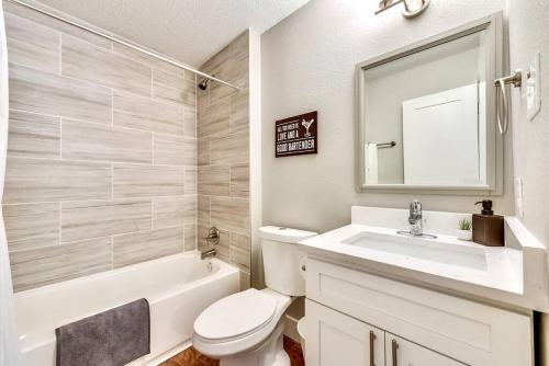 a bathroom with a toilet and a sink and a tub at Hello Gorgeous Flat near Downtown! in Dallas