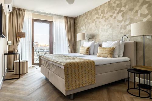ein Hotelzimmer mit einem Bett und einem großen Fenster in der Unterkunft BizStay Harbour I Scheveningen Apartments in Scheveningen