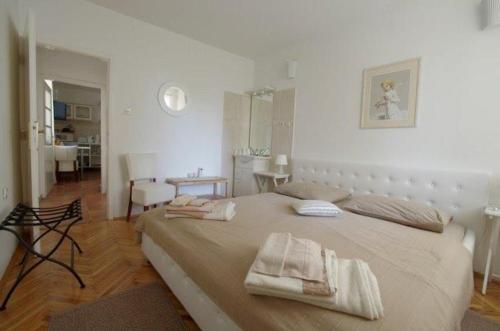 a bedroom with a large bed with towels on it at Apartments Lorenandreja in Rab