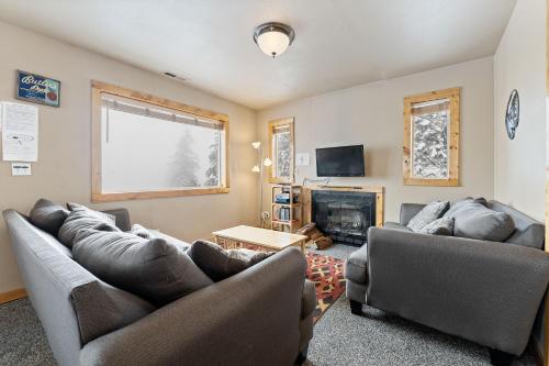 a living room with two couches and a fireplace at Echo Valley Resort + Cabins in Manson