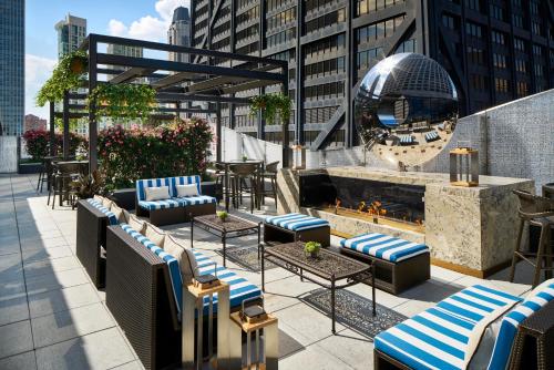 a rooftop patio with chairs and a fire fountain at The Ritz-Carlton, Chicago in Chicago