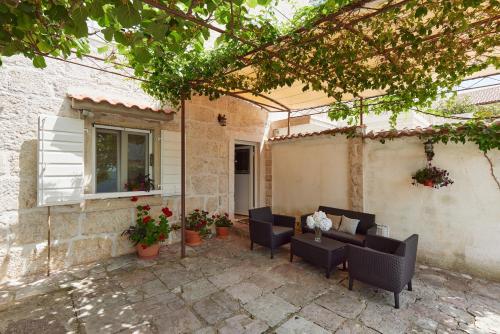 a patio with chairs and a table and a window at Konoba 224 Apartments in Kotor