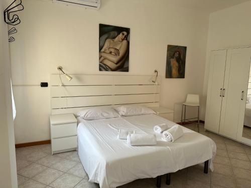 sypialnia z dużym białym łóżkiem w pokoju w obiekcie Casa Colombina w Weronie