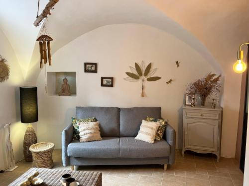a living room with a couch and a table at La Source in Saint-Saturnin-de-Lucian