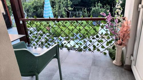 a balcony with a chair and a fence with flowers at Kuća za odmor Kod Celića in Barbarići Kravarski