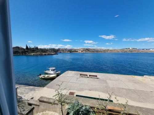 a boat is docked in a large body of water at Villa Lovorka by VILLA EVA in Omišalj