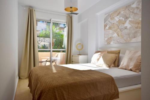 a bedroom with a bed with a large window at Bermeja view apartment in Manilva