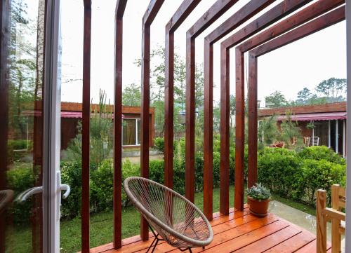 a patio with a chair on a wooden deck at Cottages in Kaprovani "Family nest" in Ureki