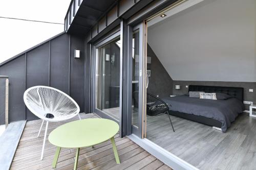 1 dormitorio con 1 cama, 1 mesa y 1 silla en Gîte Contemporain L'hirondelle, en Guémar