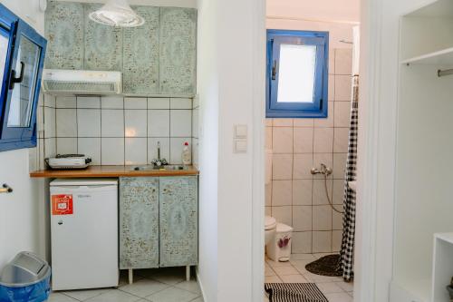 a small kitchen with a sink and a refrigerator at Villa Marina in Perdika