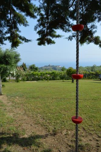 a pole with a rope attached to a tree at View of the Castle and the Sea 1 in Platamonas