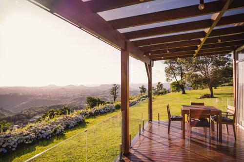 a deck with a table and chairs on a house at Josef’s Chalé in Nova Petrópolis