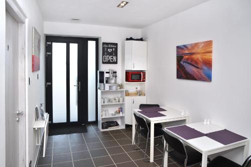 a kitchen with a table and a table and chairs at Water Lily Boutique B&B and Bungalow in Hévíz