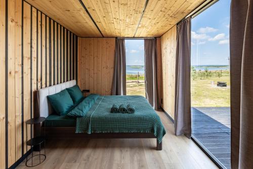 a bedroom with a bed and a large window at VyriY House in Lis