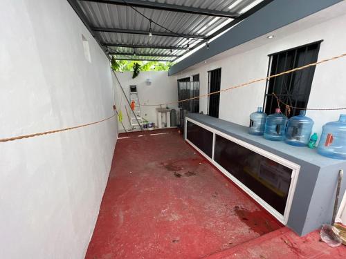 a hallway of a building with blue vases on it at Casa Santa Cruz in Chetumal