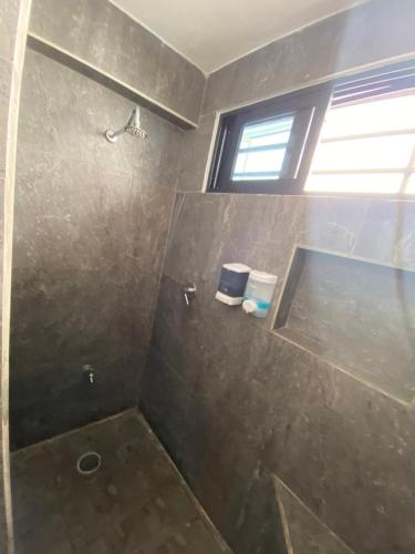 a bathroom with a shower with a glass door at Casa Santa Cruz in Chetumal