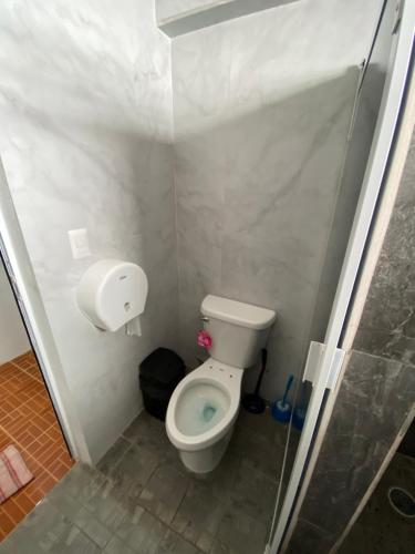 a small bathroom with a toilet in a stall at Casa Santa Cruz in Chetumal