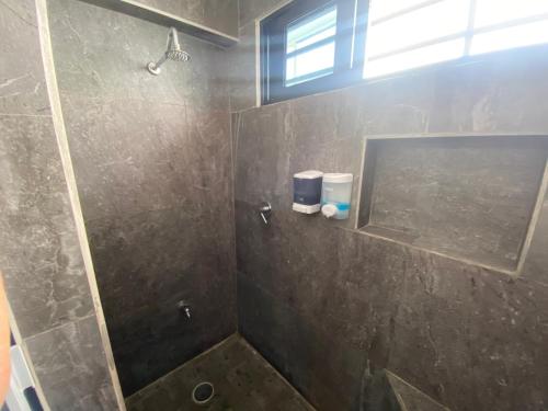 a bathroom with a shower with a glass door at Casa Santa Cruz in Chetumal