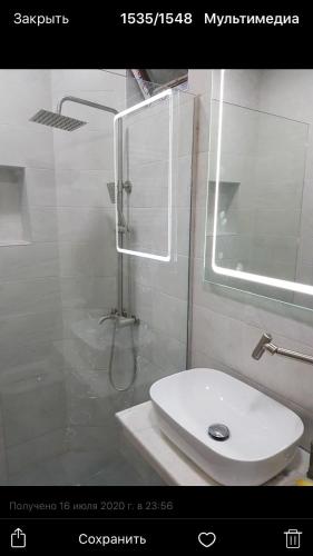a bathroom with a shower and a white sink at My House in Borjomi