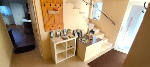 a room with a staircase with a small shelf and a stair case at Unterkunft4You-Ferienhaus-Zum-Burgfried in Usingen