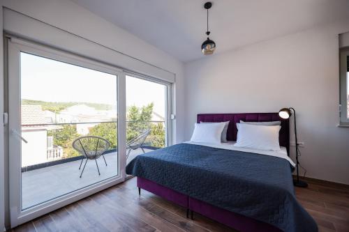 a bedroom with a bed and a large window at Residence Bella Vista in Bibinje