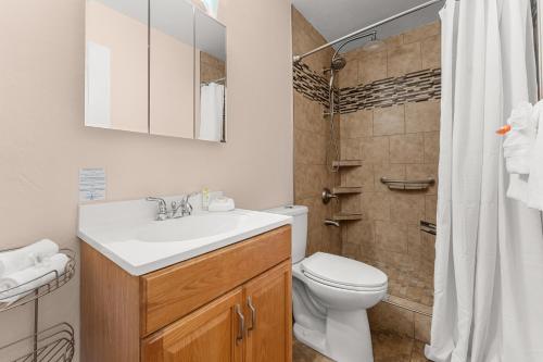 a bathroom with a sink and a toilet and a shower at Kihei Bay Surf 245 in Kihei