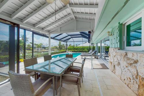 an indoor patio with a table and chairs and a pool at Marco Island Getaway in Marco Island