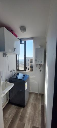 una piccola cucina con lavandino e finestra di Departamento full equipado con vista al mar a Caldera