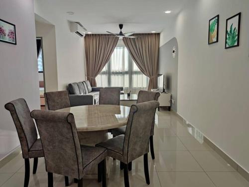 a dining room table and chairs in a living room at M Vertica kl 3r2b 7 pax cosy house 3min mrt, sunway velocity mall, 8min ikea in Kuala Lumpur