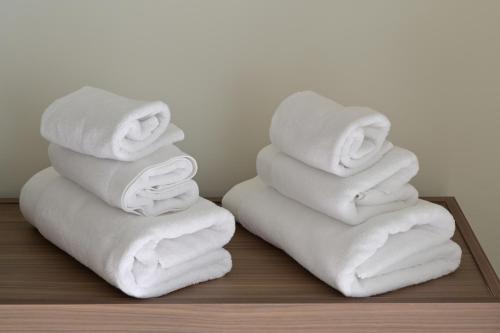 a stack of towels sitting on a table at Relais Ulivo Ariana in Gaeta
