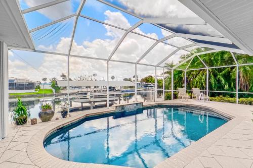 an indoor swimming pool with a glass ceiling at Water View Wonder in Matlacha