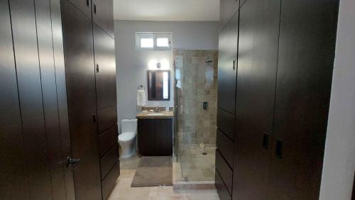 a bathroom with a shower and a toilet and a sink at Private Villa 115 in Gated Community Pet-friendly in Cabo San Lucas