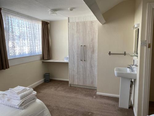 a bathroom with a sink and a toilet and a shower at Sylvern House in Scarborough