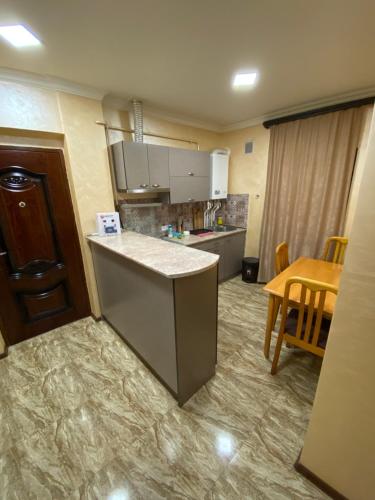a kitchen with a counter and a table in a room at My Guesthome in Yerevan